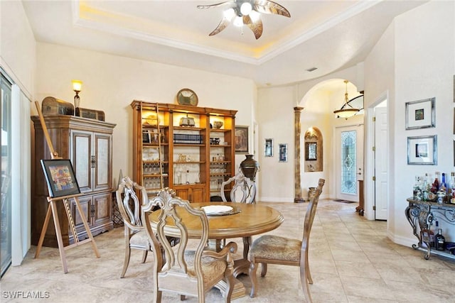 dining room with ceiling fan, light tile patterned floors, and a tray ceiling