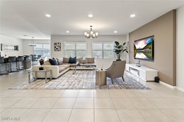 tiled living room with a notable chandelier