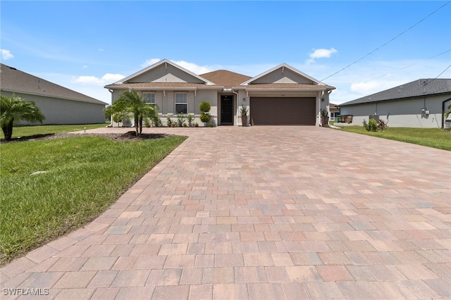 single story home with a garage and a front lawn