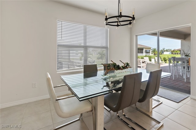 dining space featuring a notable chandelier and light tile patterned flooring