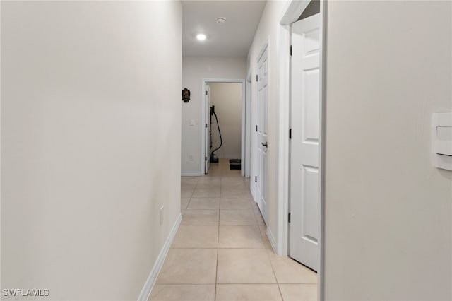 hall with light tile patterned floors