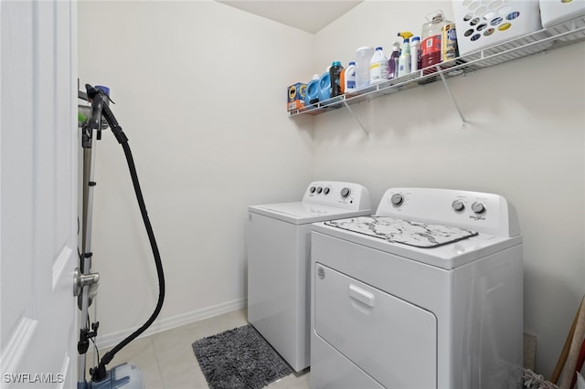 laundry room with washer and dryer and light tile patterned floors