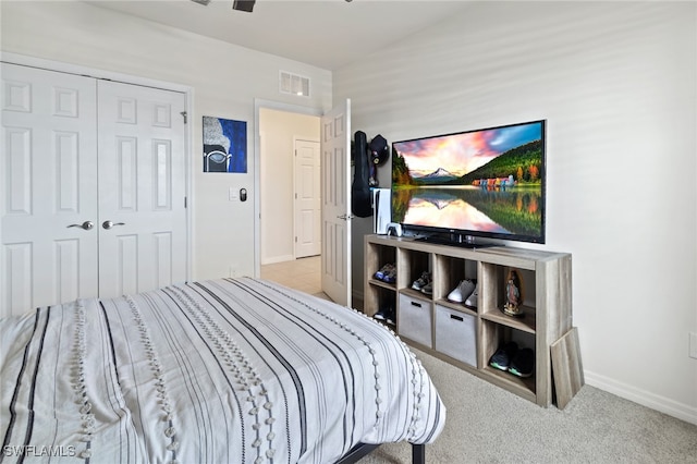 bedroom featuring a closet and light colored carpet