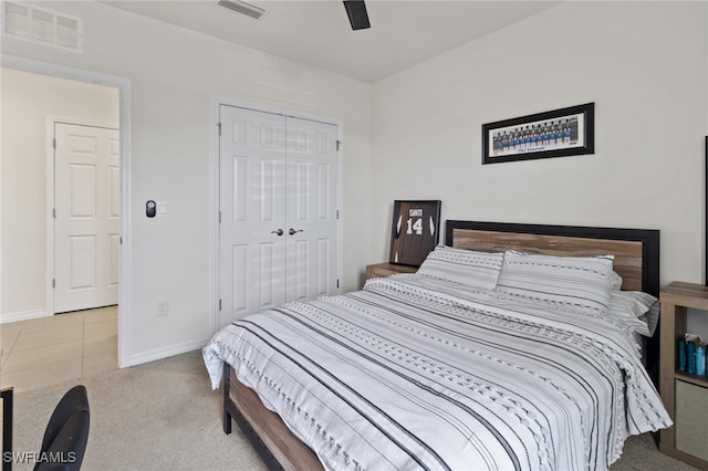 carpeted bedroom featuring a closet and ceiling fan