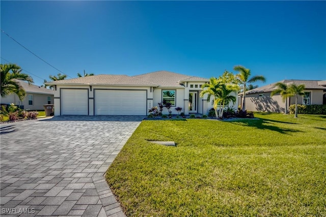 view of front of property featuring a front lawn and a garage