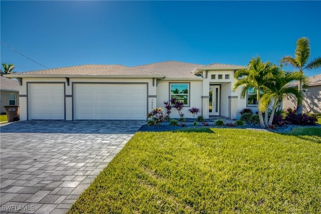 view of front of home featuring a garage and a front lawn