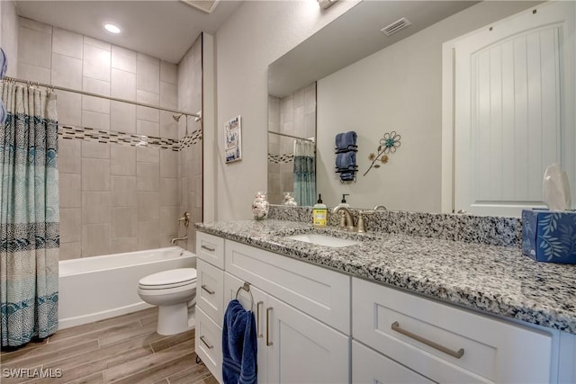 full bathroom featuring wood-type flooring, vanity, toilet, and shower / bathtub combination with curtain