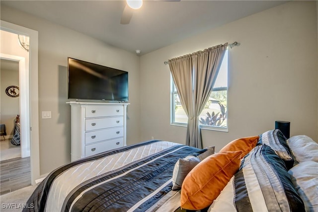 bedroom with ceiling fan and wood-type flooring