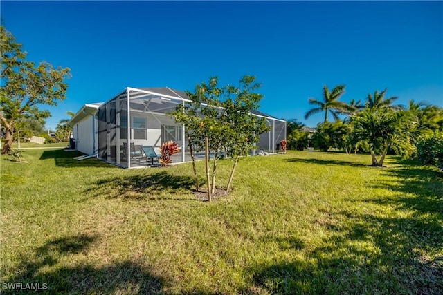 view of yard featuring a patio and a lanai