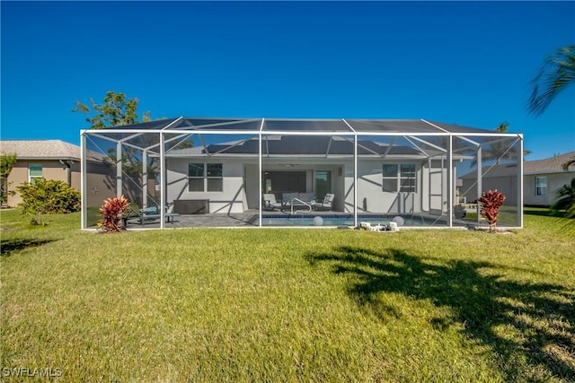 rear view of house featuring a yard, glass enclosure, and a patio area