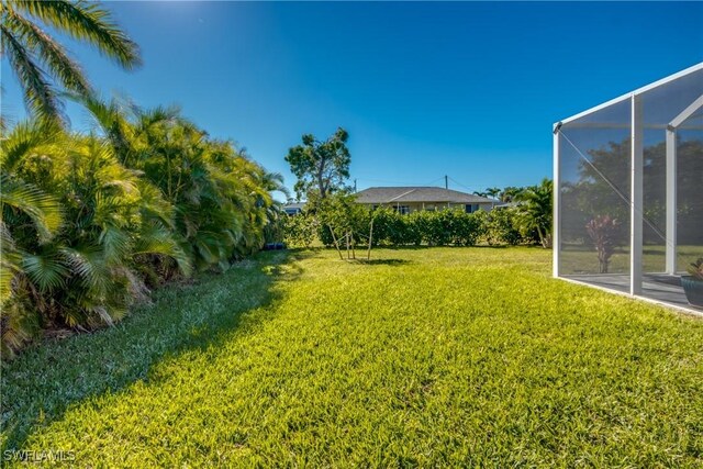 view of yard featuring a lanai