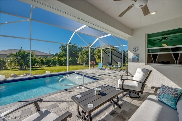 view of swimming pool with a lanai, a yard, and a patio