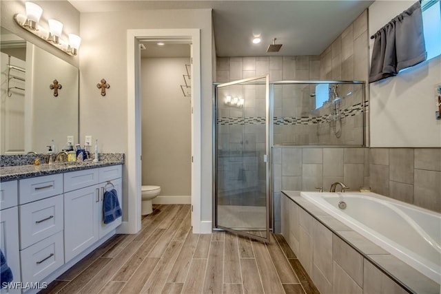 full bathroom with vanity, independent shower and bath, and toilet