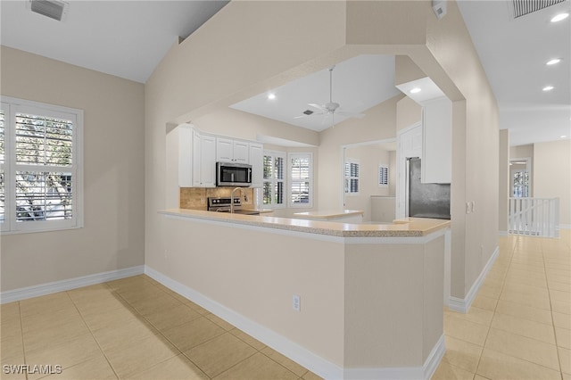 kitchen with a healthy amount of sunlight, kitchen peninsula, and stainless steel appliances