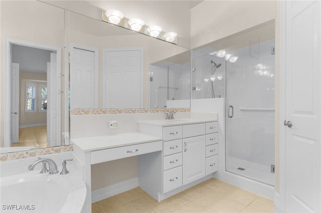 bathroom with tile patterned flooring, vanity, and a shower with shower door