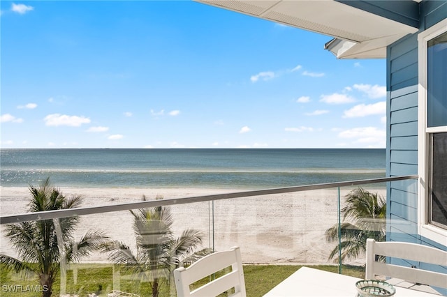 balcony with a water view and a beach view