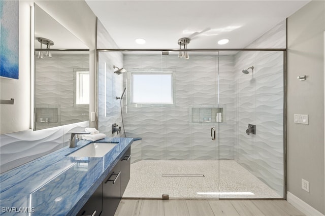 bathroom featuring hardwood / wood-style floors, vanity, and walk in shower