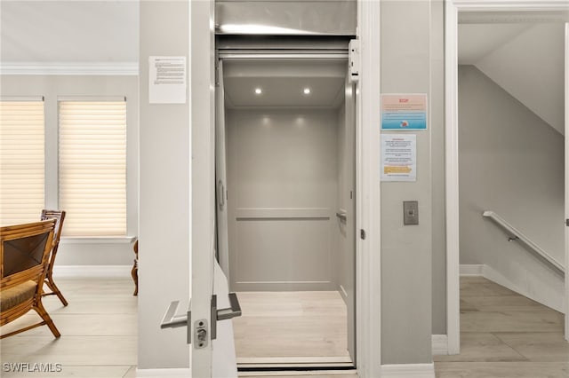 room details featuring elevator and ornamental molding