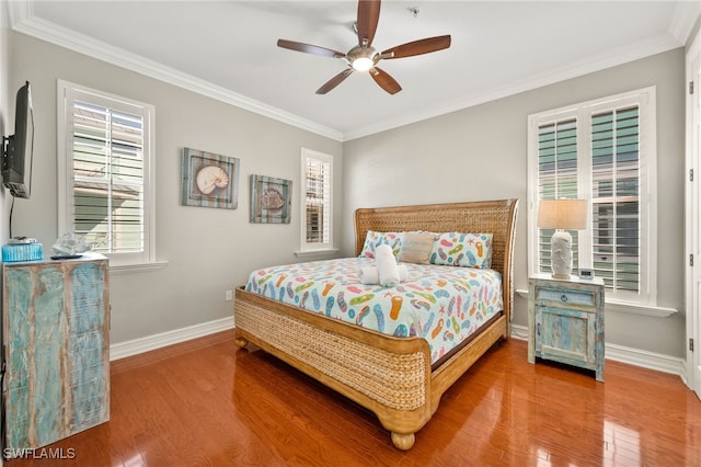 bedroom with ceiling fan, hardwood / wood-style floors, and ornamental molding