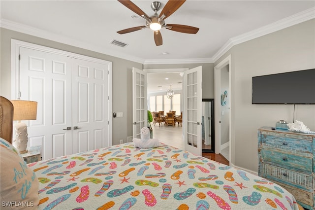 bedroom featuring french doors, ornamental molding, and a closet