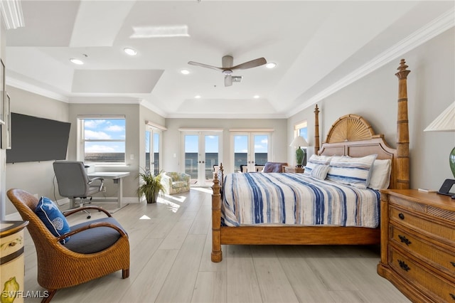 bedroom featuring ceiling fan, a raised ceiling, light hardwood / wood-style floors, access to outside, and ornamental molding