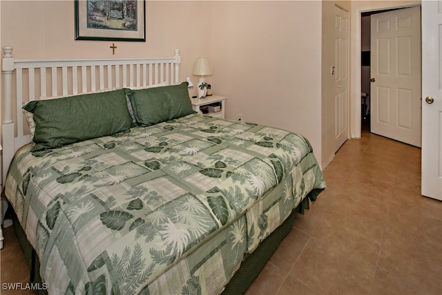 bedroom featuring light tile patterned floors and a closet