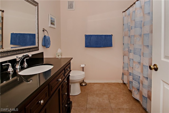 bathroom with walk in shower, tile patterned flooring, vanity, and toilet