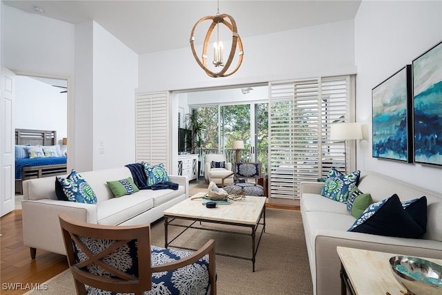 living room with hardwood / wood-style floors and a chandelier