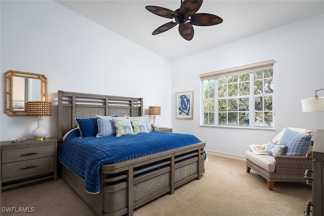 carpeted bedroom with ceiling fan and lofted ceiling