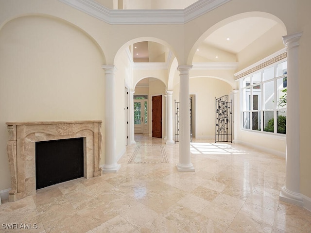 unfurnished living room featuring a high end fireplace, a high ceiling, and ornamental molding