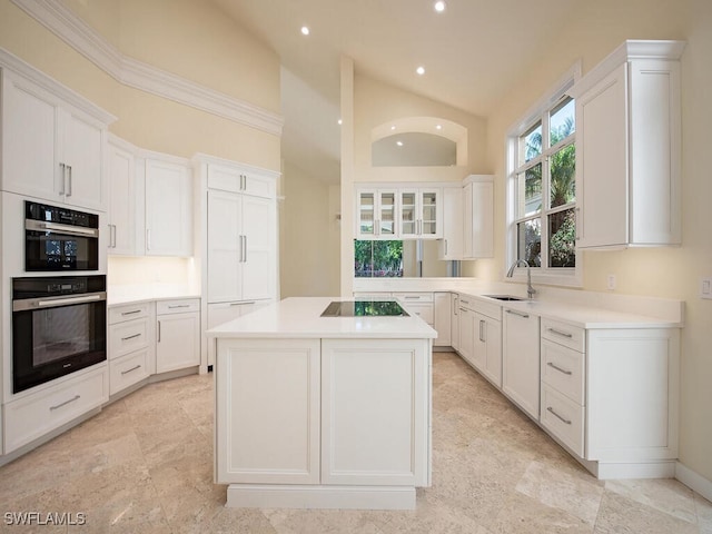 kitchen with white cabinets, a center island, and black electric cooktop