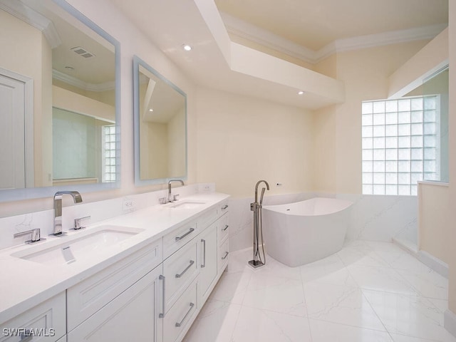 bathroom with a washtub, vanity, and ornamental molding