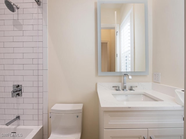 full bathroom featuring vanity, tiled shower / bath combo, and toilet