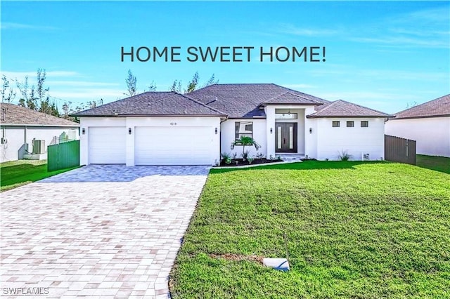 view of front of property with a garage and a front lawn