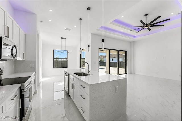 kitchen with appliances with stainless steel finishes, white cabinetry, and hanging light fixtures