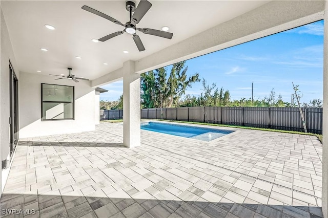 view of swimming pool with ceiling fan and a patio