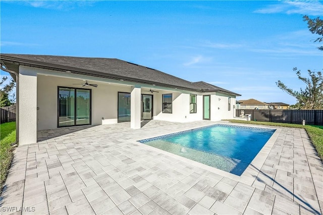 view of swimming pool with ceiling fan and a patio area