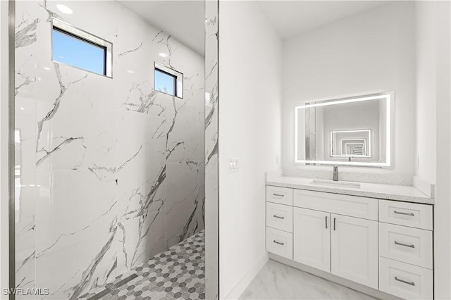 bathroom featuring vanity and tiled shower