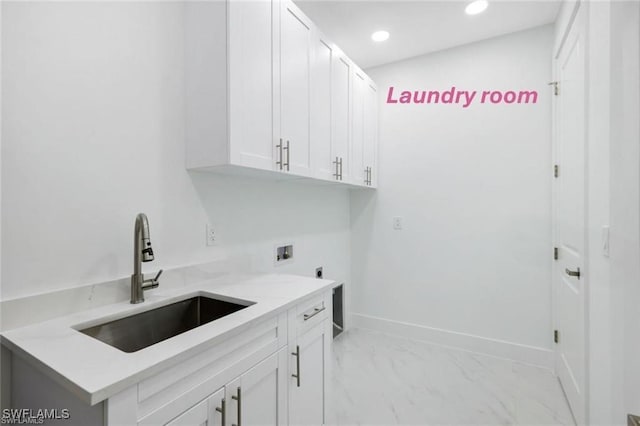 clothes washing area with cabinets, washer hookup, electric dryer hookup, and sink