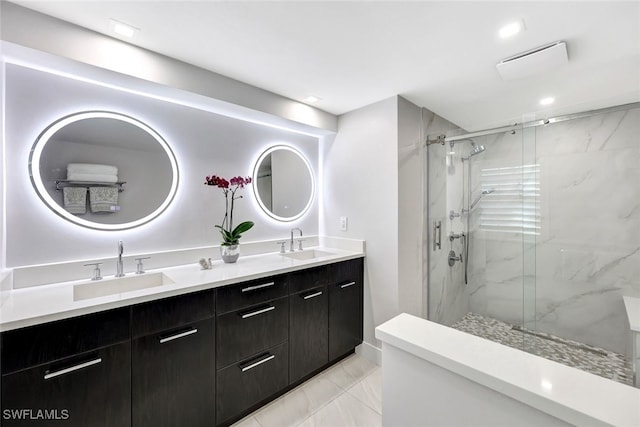 bathroom featuring vanity and a shower with shower door