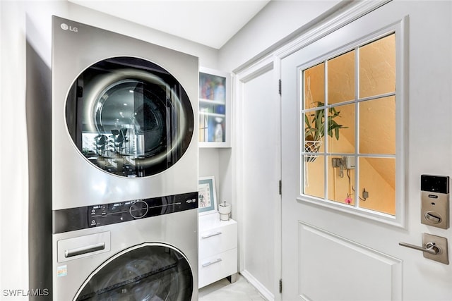 laundry area with stacked washing maching and dryer