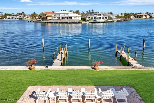 dock area featuring a lawn and a water view