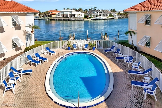 view of swimming pool featuring a water view