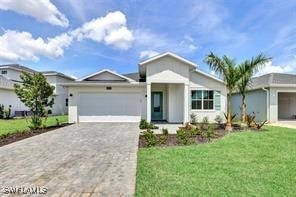 ranch-style home with a garage and a front lawn