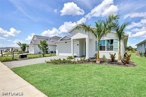 view of front of house with a front yard and a garage