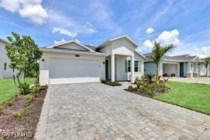 view of front of home with a front yard and a garage