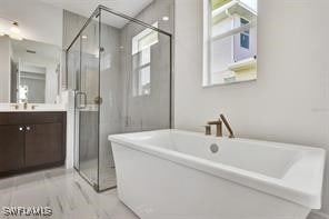 bathroom with vanity and independent shower and bath