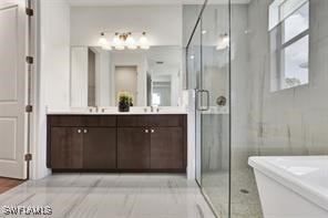 bathroom with shower with separate bathtub, vanity, and a wealth of natural light