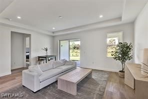 living room with a wealth of natural light and wood-type flooring