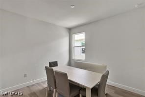 dining area with hardwood / wood-style floors